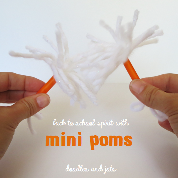 Mini straw pom poms, straws are orange, pom poms are white yarn
