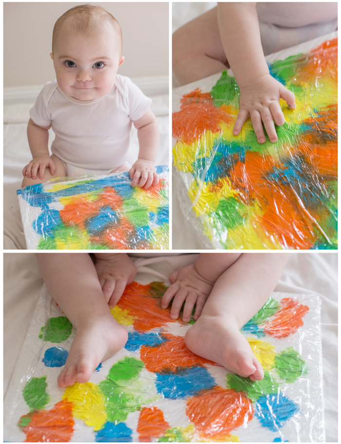 Image shows a baby doing fingerpainting art. From Adore Cherish Love.