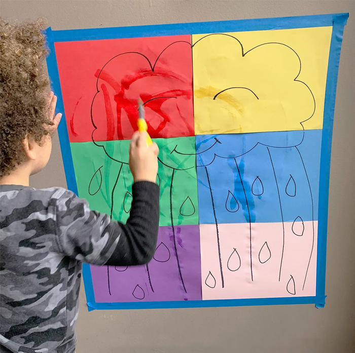 Image shows a toddler doign rain painting. From Happy Toddler Play Time.