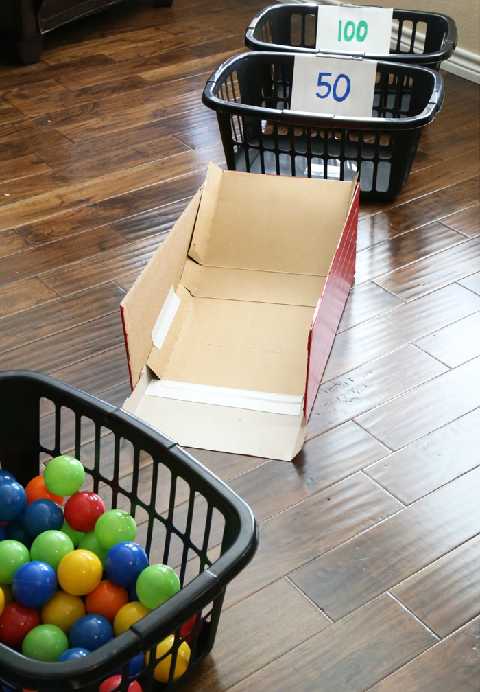 Image shows laundry baskets filled with colored balls for an indoor game. From Frugal fun 4 boys
